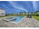 Backyard pool and spa with loungers, landscaping, and space for outdoor activities under clear skies at 280 Burma St, Kissimmee, FL 34747