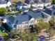 Aerial view of townhomes with dark rooftops, surrounded by lush trees in a meticulously planned community at 2979 Upper Park Rd, Orlando, FL 32814