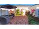 Relaxing backyard featuring a brick patio, lounge seating, a garden, and a fence at 2979 Upper Park Rd, Orlando, FL 32814