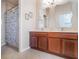 Bathroom featuring double sinks, wood cabinets, and a shower with a floral curtain at 2979 Upper Park Rd, Orlando, FL 32814