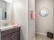 Half-bathroom features a stylish mirror, vanity with sink, and neutral-toned walls at 2979 Upper Park Rd, Orlando, FL 32814