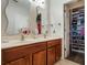 Bathroom featuring double sinks, wood cabinets, and a view into the walk-in closet at 2979 Upper Park Rd, Orlando, FL 32814