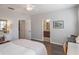 Bright bedroom with a ceiling fan, a connected bathroom, and wood-look floors at 2979 Upper Park Rd, Orlando, FL 32814