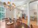 Open concept dining area with hardwood floors, chandelier, and view into the living room at 2979 Upper Park Rd, Orlando, FL 32814