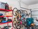 Garage features a collection of bikes hanging neatly on the wall and red shelving for organized storage solutions at 2979 Upper Park Rd, Orlando, FL 32814