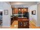 Stylish kitchen with wood cabinets, granite countertops, and a center island for food preparation at 2979 Upper Park Rd, Orlando, FL 32814