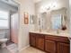 Elegant main bathroom with a dual-sink vanity, tile floor, and a shower at 2979 Upper Park Rd, Orlando, FL 32814