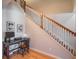 A staircase with wooden banister, leading up from a foyer area with hardwood floors and desk at 2979 Upper Park Rd, Orlando, FL 32814
