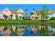 Picturesque community homes with colorful facades, lush landscaping, and scenic lakefront views at 3000 Limbo Ln # 102, Kissimmee, FL 34746