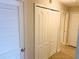 Hallway featuring closet with sliding doors and another white closet at 3000 Limbo Ln # 102, Kissimmee, FL 34746