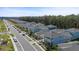 Community aerial view with houses in a row and many with covered decks at 3114 Meleto Blvd, New Smyrna Beach, FL 32168