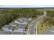 New construction homes nestled against a tree line with sidewalks and blacktop roads in a Primary-planned community at 3114 Meleto Blvd, New Smyrna Beach, FL 32168