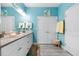 Bright bathroom boasts double sink vanity, ample lighting, and a coastal-themed accent rug at 3114 Meleto Blvd, New Smyrna Beach, FL 32168