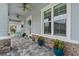 Charming front porch featuring decorative plants and stone accents on the home's exterior at 3114 Meleto Blvd, New Smyrna Beach, FL 32168