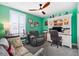 Stylish home office with custom built-ins, a comfortable sofa, and a neutral color scheme at 3114 Meleto Blvd, New Smyrna Beach, FL 32168