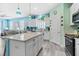 Airy eat-in kitchen with white cabinets, stainless appliances, and a center island for casual dining at 3114 Meleto Blvd, New Smyrna Beach, FL 32168