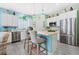 Bright kitchen featuring an island with barstool seating, stainless steel appliances, and ample counter space at 3114 Meleto Blvd, New Smyrna Beach, FL 32168