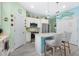 Bright eat-in kitchen features white cabinets, modern appliances, and a center island with seating at 3114 Meleto Blvd, New Smyrna Beach, FL 32168
