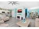 Open living space featuring a modern fireplace, staircase, and stylish dining area at 3114 Meleto Blvd, New Smyrna Beach, FL 32168