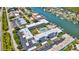 Aerial view showcasing the pool, waterways, docks and surrounding community of the property at 315 N Causeway # B302, New Smyrna Beach, FL 32169