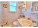 Charming powder room featuring floral wallpaper, a vanity, and a round toilet seat at 315 N Causeway # B302, New Smyrna Beach, FL 32169