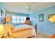 Bedroom featuring bright walls, shuttered windows and neutral carpeting in a cozy living space at 315 N Causeway # B302, New Smyrna Beach, FL 32169