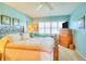 Comfortable bedroom with a bed, dresser and a cozy sitting area bathed in natural light at 315 N Causeway # B302, New Smyrna Beach, FL 32169