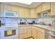 Functional kitchen featuring white appliances, bright lighting and fish-themed tile accents at 315 N Causeway # B302, New Smyrna Beach, FL 32169