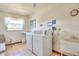 Convenient on-site laundry room with washer, dryer, and utility sink at 315 N Causeway # B302, New Smyrna Beach, FL 32169