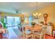 Cozy living and dining area with wood floors, comfortable seating and slider to balcony at 315 N Causeway # B302, New Smyrna Beach, FL 32169