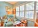 Cozy sitting area with a comfortable recliner and bright, shuttered windows at 315 N Causeway # B302, New Smyrna Beach, FL 32169