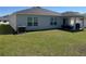 Spacious backyard featuring green grass, covered patio and home's exterior at 3166 Sweet Acres Pl, St Cloud, FL 34772