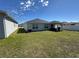 Spacious backyard featuring green grass, covered patio and home's exterior at 3166 Sweet Acres Pl, St Cloud, FL 34772