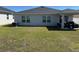 Spacious backyard featuring green grass, covered patio and home's exterior at 3166 Sweet Acres Pl, St Cloud, FL 34772