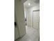 Tiled hallway leading to a bedroom and storage area at 3166 Sweet Acres Pl, St Cloud, FL 34772