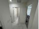 Hallway featuring tiled flooring, leading to bathroom and bedroom at 3166 Sweet Acres Pl, St Cloud, FL 34772