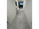 Hallway featuring tiled flooring, neutral colored walls and white modern decor at 3166 Sweet Acres Pl, St Cloud, FL 34772