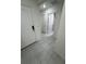 Hallway featuring tiled flooring, neutral colored walls and white doors at 3166 Sweet Acres Pl, St Cloud, FL 34772