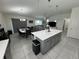 Open-concept kitchen with granite island, stainless steel appliances, and views of the dining and living areas at 3166 Sweet Acres Pl, St Cloud, FL 34772