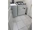 This well-lit laundry room has a washer and dryer on tiled floors at 3166 Sweet Acres Pl, St Cloud, FL 34772