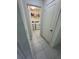 A clean and functional laundry room with a washer, dryer, and shelving for storage at 3166 Sweet Acres Pl, St Cloud, FL 34772