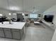 Spacious living room with large sectional sofa, modern decor, and open flow to the kitchen and dining areas at 3166 Sweet Acres Pl, St Cloud, FL 34772