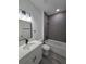 Modern bathroom with stylish gray tiled shower, elegant vanity, and sleek fixtures; a luxurious retreat at 3519 Sw 131St Place St, Ocala, FL 34473