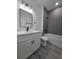 Modern bathroom with stylish gray tiled shower, elegant vanity, and sleek fixtures; a luxurious retreat at 3519 Sw 131St Place St, Ocala, FL 34473