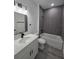 Modern bathroom with stylish gray tiled shower, elegant vanity, and sleek fixtures; a luxurious retreat at 3519 Sw 131St Place St, Ocala, FL 34473