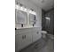 Modern bathroom featuring dual sinks, white cabinets and a glass-enclosed shower at 3519 Sw 131St Place St, Ocala, FL 34473