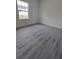 Bright bedroom features a large window and luxury vinyl plank flooring at 3519 Sw 131St Place St, Ocala, FL 34473