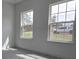 Bright bedroom with two large windows offering abundant natural light and providing pleasant views at 3519 Sw 131St Place St, Ocala, FL 34473