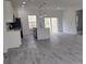 Open-concept kitchen boasts an island, stainless appliances and a view of the backyard at 3519 Sw 131St Place St, Ocala, FL 34473
