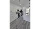 Bright kitchen boasts quartz counters, stainless appliances, a large island and stylish gray wood-look floors at 3519 Sw 131St Place St, Ocala, FL 34473